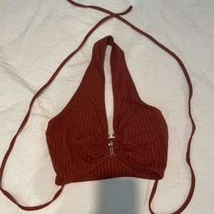 brown crop top with gold hoop in the front